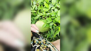 Girl pissing on the coconut in the jungle grass