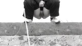 Outdoor piss mature MILF with a big bush on her cunt.