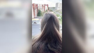I fuck a girl while she stands on the balcony and looks out the window