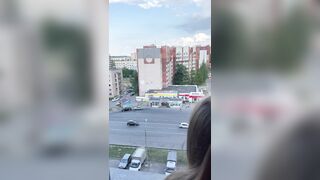 I fuck a girl while she stands on the balcony and looks out the window