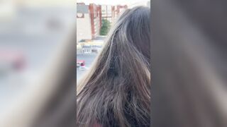 I fuck a girl while she stands on the balcony and looks out the window