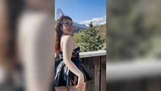 Young student shows off her charms against the backdrop of mountains