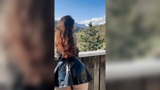 Young student shows off her charms against the backdrop of mountains